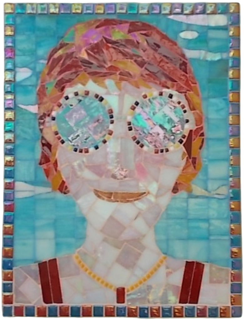 Title: Sunspectacled Woman. A woman wearing large, round sunspecs gazes out from this picture, a blue sky behind her. Her hair is shades of red, contrasting with the sky. Her shoulders are just visible as are her necklace and vest straps.